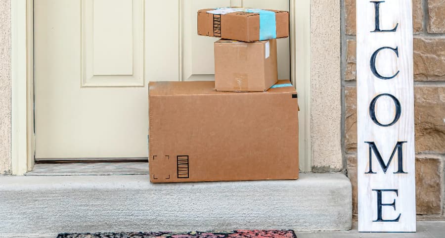 Boxes by the door of a residence with a welcome sign in Prescott